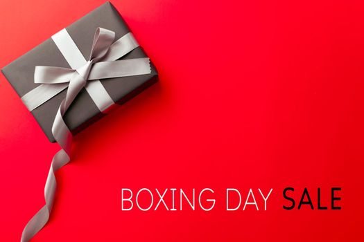 Boxing Day sale, a gift box on red background