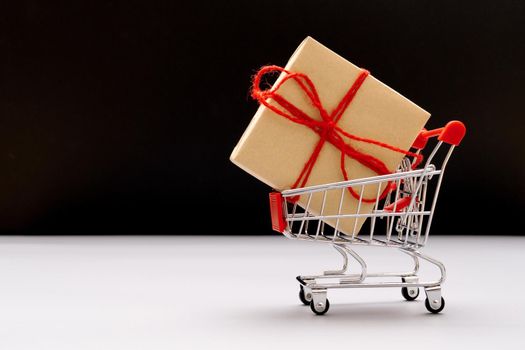 Boxing day sale, shopping cart and gift box with copy space