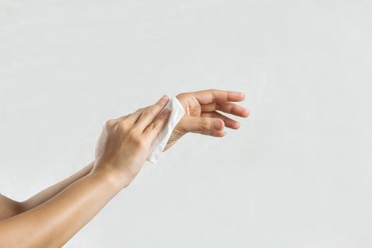 Woman cleaning her hands with white soft tissue paper. isolated on a white backgrounds