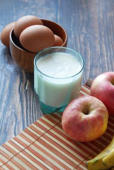 healthy snack concept with milk and apple on table