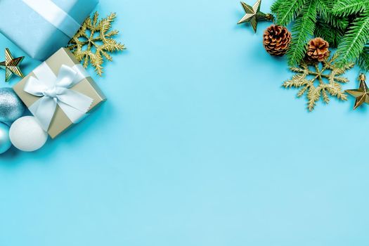 Christmas present and pine tree with xmas decoration on blue background