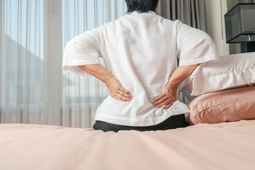 Old woman back pain at home, health problem concept