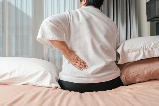 Old woman back pain at home, health problem concept