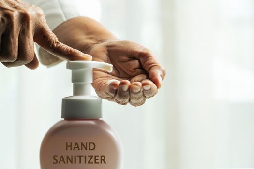 Hand sanitizer foam, hand cleansing concept, senior hand apply alcohol gel or anti bacteria soap to make cleaning and clear virus, germ, bacteria