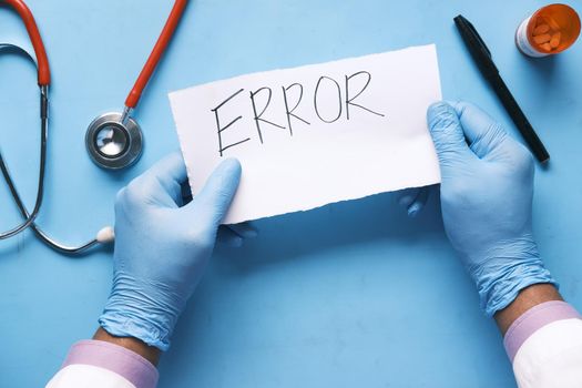 medical error text on a paper with pills and stethoscope on table