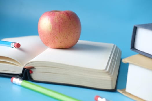 black to school concept with apple on notepad on table