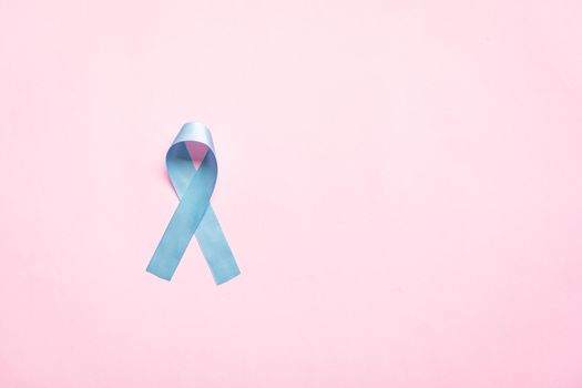 November light blue ribbon on pink background with copy space, Prostate cancer awareness month, men's health concept