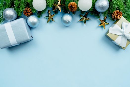 Christmas present and pine tree with xmas decoration on blue background