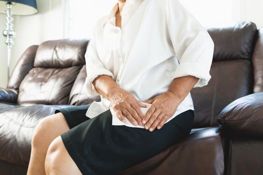 Hip pain of senior woman at home, healthcare problem of senior concept