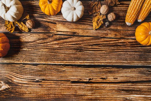 Happy Thanksgiving Day with pumpkin and nut on wooden table