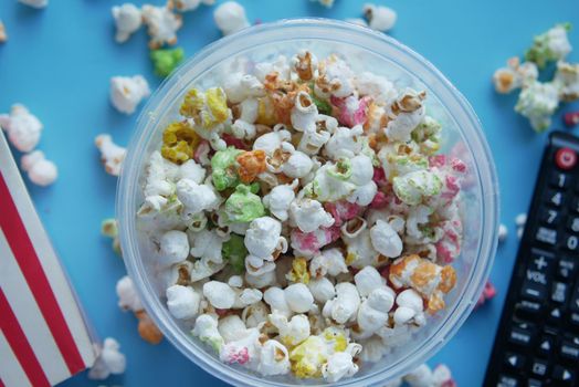 high angle view of popcorn spilling from container .
