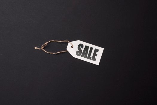 Black friday concept. Sale shopping tag on dark background