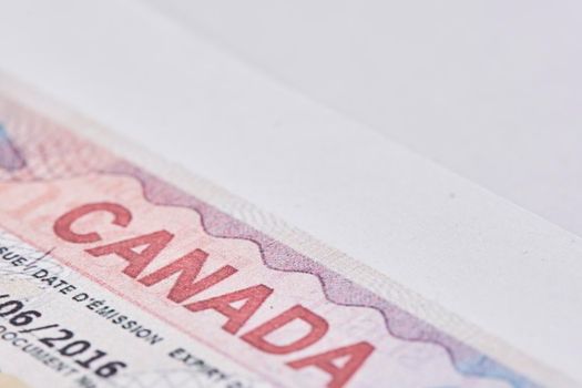 Tashkent, Uzbekistan - 13 August, 2021: Macro shot of Canadian visa. Close-up Canada resident immigration visa in passport