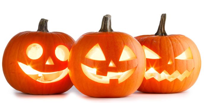 Three glowing Halloween Pumpkin lanterns isolated on white background