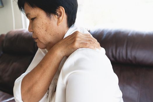 neck and shoulder pain, old woman suffering from neck and shoulder injury, health problem concept