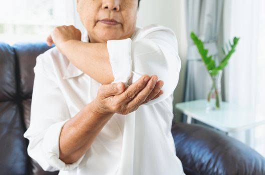 elbow pain old woman suffering from elbow pain at home, healthcare problem of senior concept