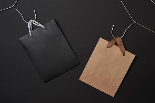 Black Friday concept. Black and craft paper shopping bags on dark background