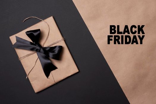 Black friday concept. Shopping bags on split black and craft background.