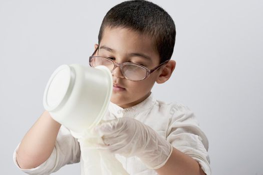 Portrait of a mixed race kid making experiments at home