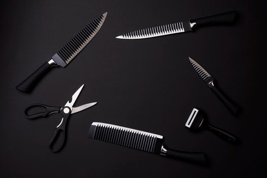Black Friday concept. A kitchen set of black knifes on black background. Sharp knifes, kitchen slicer and scissors