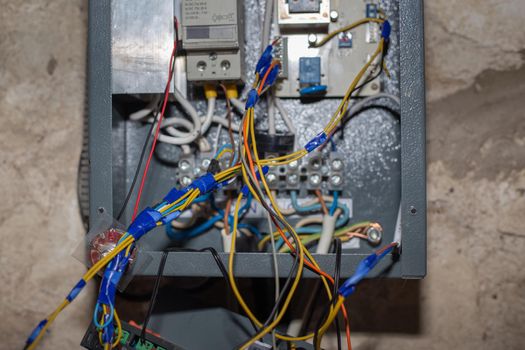 Installation of wire contacts in an electric boiler for heating a house, selective focus.