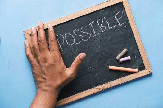 young man hand over impossible text