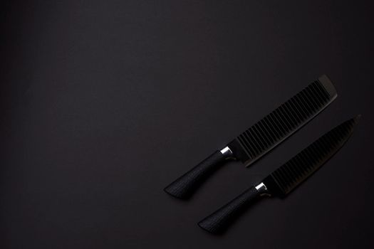 Black friday concept. Set of sharp kitchen knifes. Black knifes on dark background