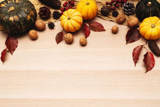 Happy Thanksgiving Day with pumpkin and nut on wooden background