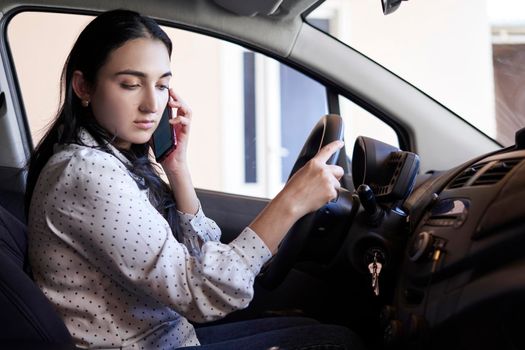 Unsafe driving. Young multiracial woman talking on the phone while driving. Distracted Driving. Female driving and talking on cellphone