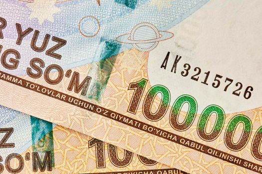 Macro shot of uzbek sum banknote. Pile of Uzbek sums. Uzbek currency money bill. A stack of one hundred thousand Uzbek sum. 100000 sum