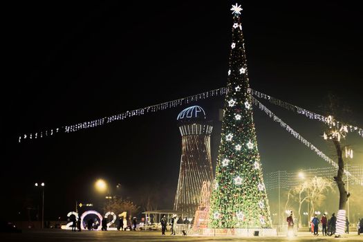 Tashkent, Uzbekistan - 15 December, 2020: Celebrating Christmas in a small city. A big city Xmas Tree with illuminated lights