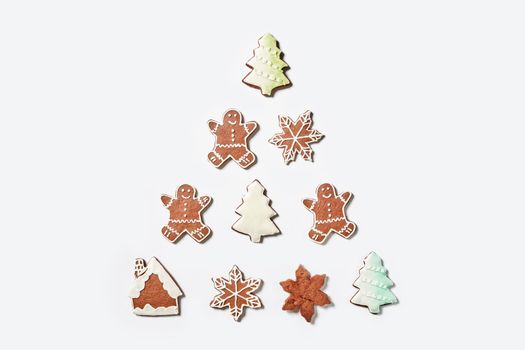 Xmas sweets on white background making form of Christmas tree