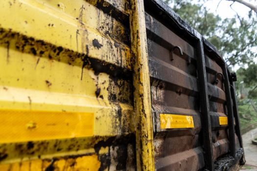 Old rusted carrying truck, colored in yellow color.