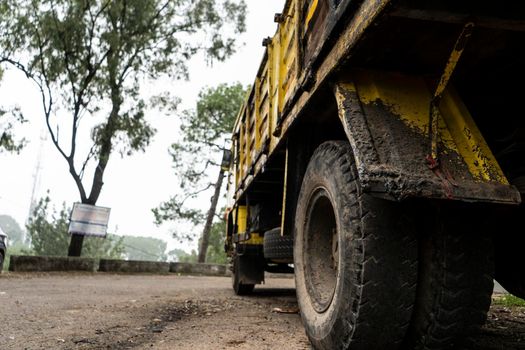 Low angle shot of a old rusted carrying truck parked.