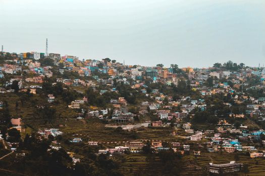 A landscape of a city in the mountains, captured from a tele photo lens.