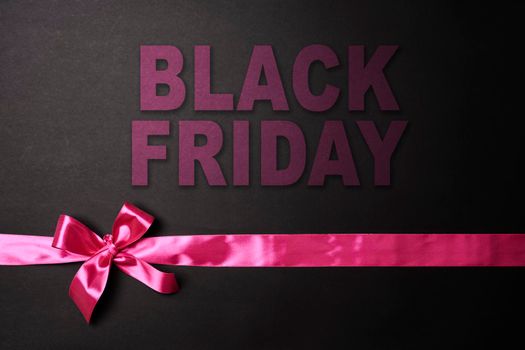 Black Friday concept. Black Friday sale on dark background. Colored ribbons on black