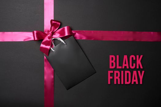 Black Friday concept. Black Friday sale on dark background. Colored ribbons on black
