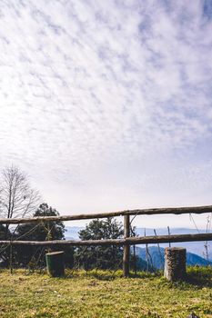 A view from the top of the mountain with wooden fence in the foreground.