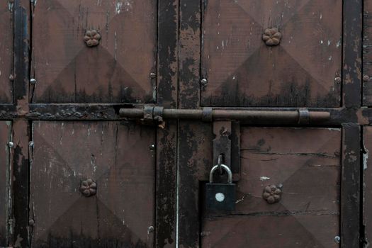 old and rusty latch and handle on metal door. old castle, house, basement or room door