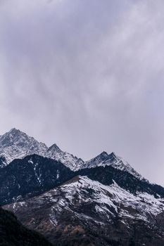Landscape of mountain range covered with snow in Manali during summers. Mountain peak in snow.