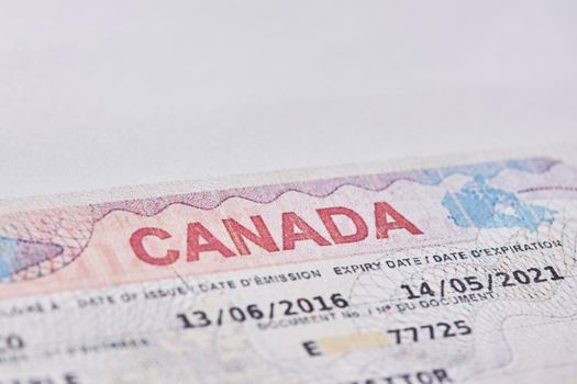 Tashkent, Uzbekistan - 13 August, 2021: Macro shot of Canadian visa. Close-up Canada resident immigration visa in passport