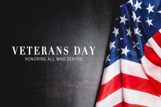 Veterans day. Honoring all who served. American flag on gray background with copy space.