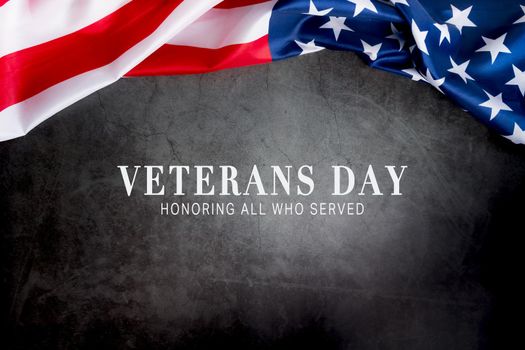 Veterans day. Honoring all who served. American flag on gray background with copy space.