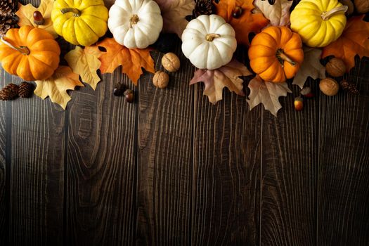 Happy Thanksgiving Day with pumpkin and nut on wooden table