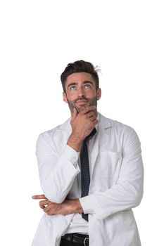 Young doctor surgeon man over isolated white background with hand on chin thinking about question, pensive expression. Doubt concept.