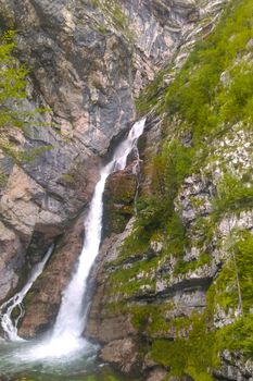 View of the waterfall in the mountains. Fresh pleasant breeze of water