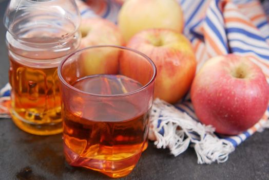 glass of apple juice and apple on table