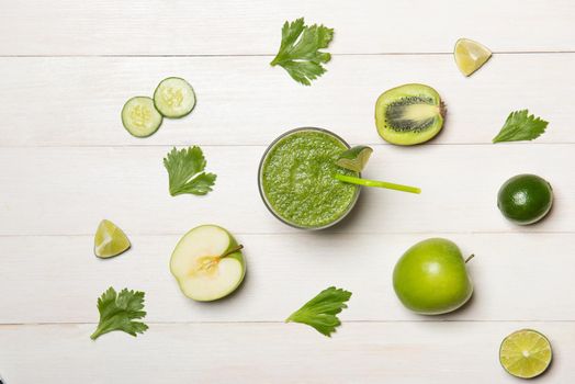 Detox concept. Glass jar of fresh drink green smoothie, spinach leaves, cucumber, apple, lime fruit.