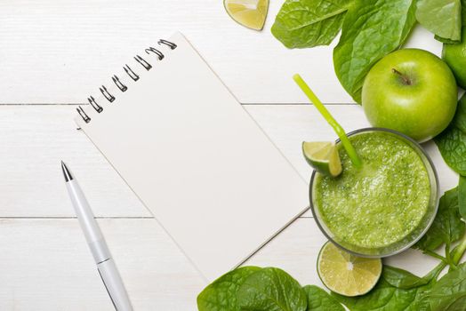 Detox concept. Glass jar of fresh drink green smoothie, spinach leaves, cucumber, apple, lime fruit.