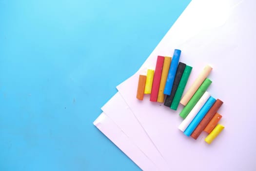 Color pencils on a papers on table .